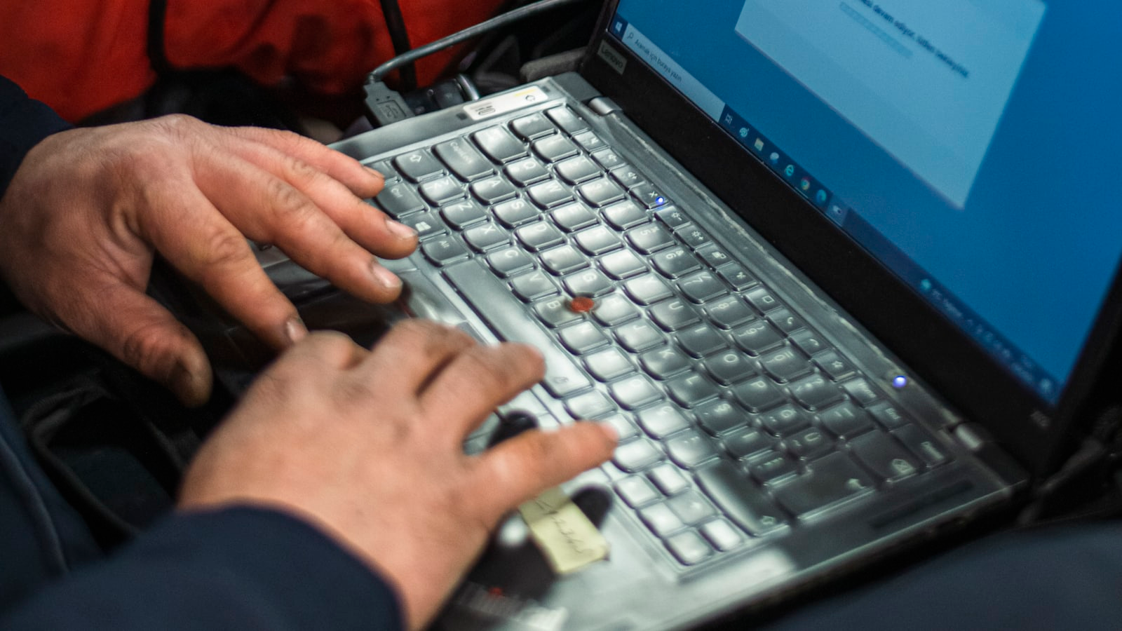 A diagnostic laptop connected to a car to read fault codes